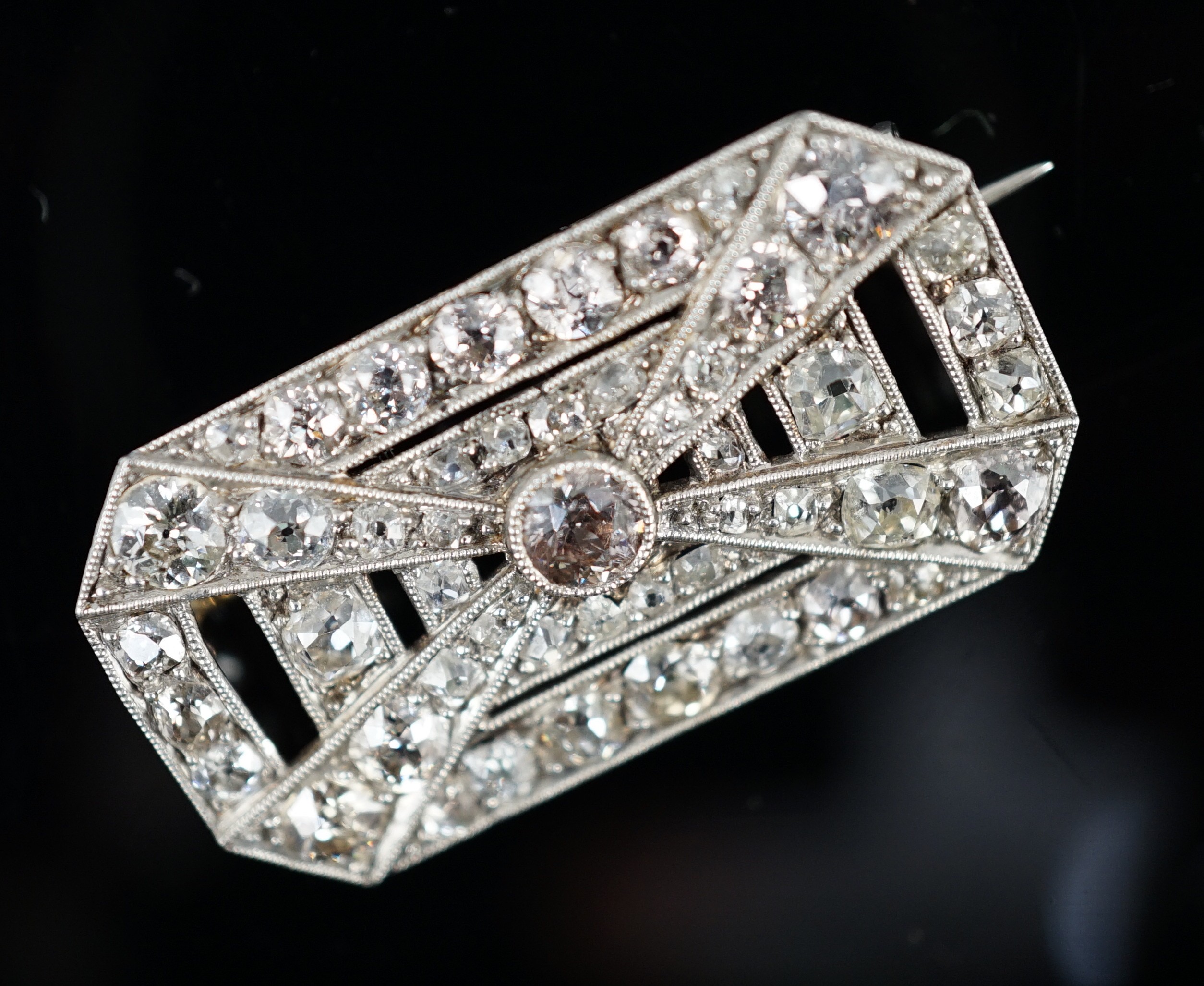 A 1930's/1940's Art Deco white gold, platinum and graduated diamond cluster millegrain set octagonal brooch